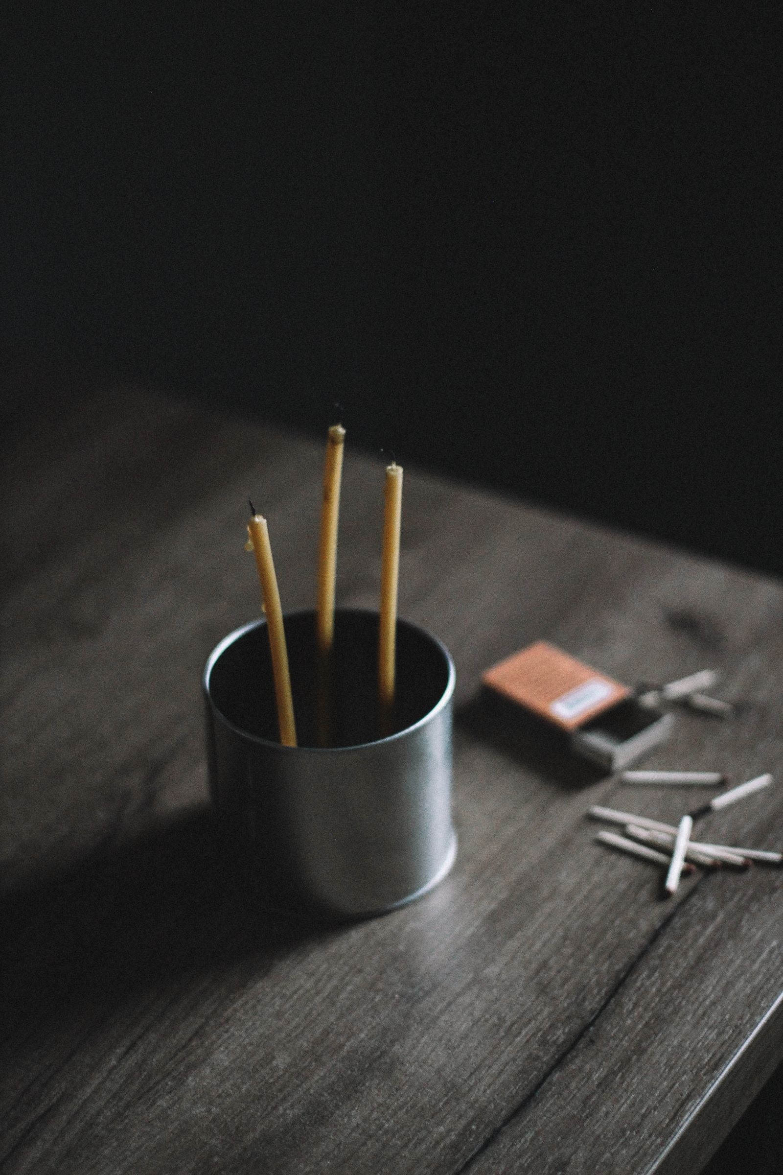 Unlit candle, waiting in its tin
