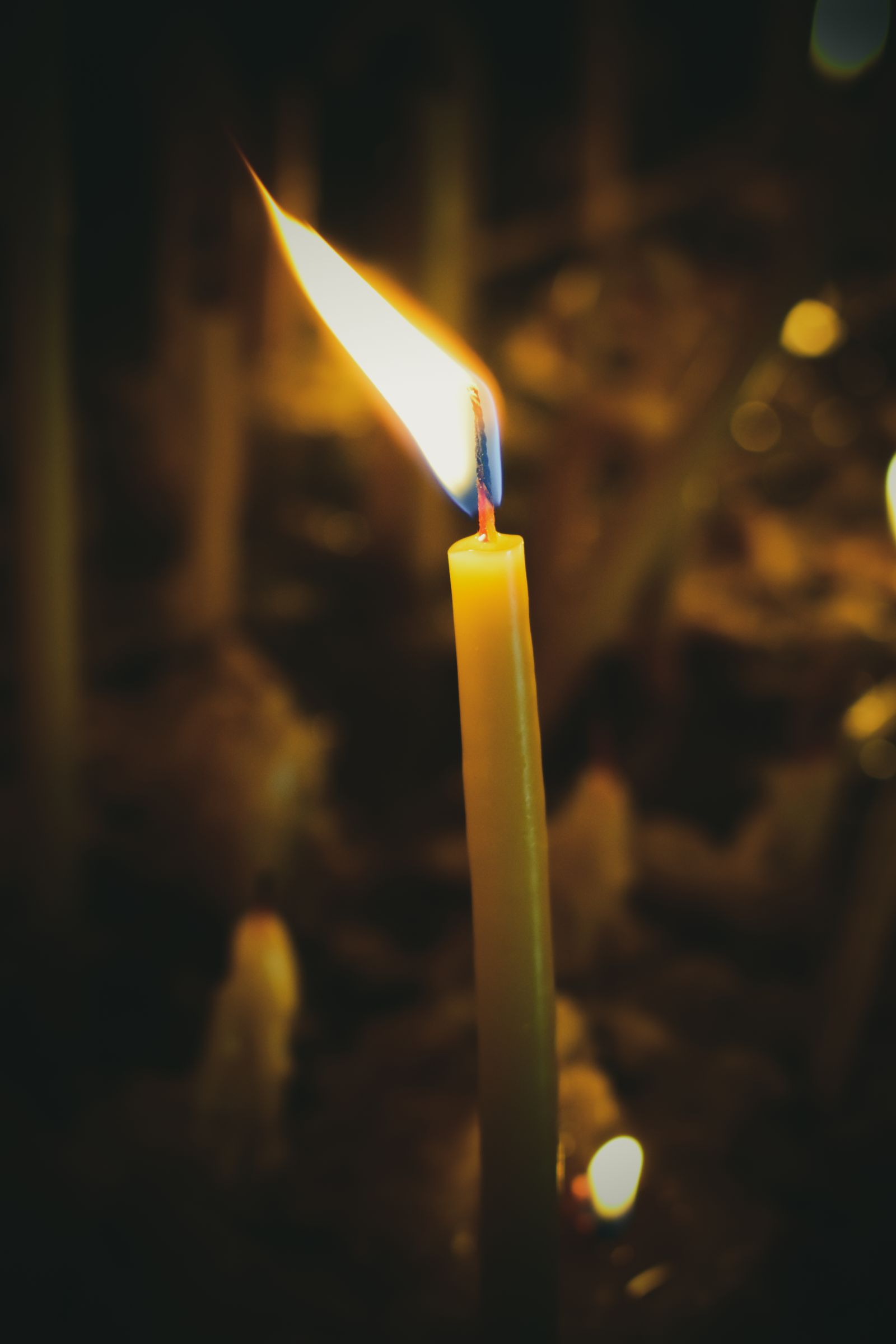 Lit candle, golden flame