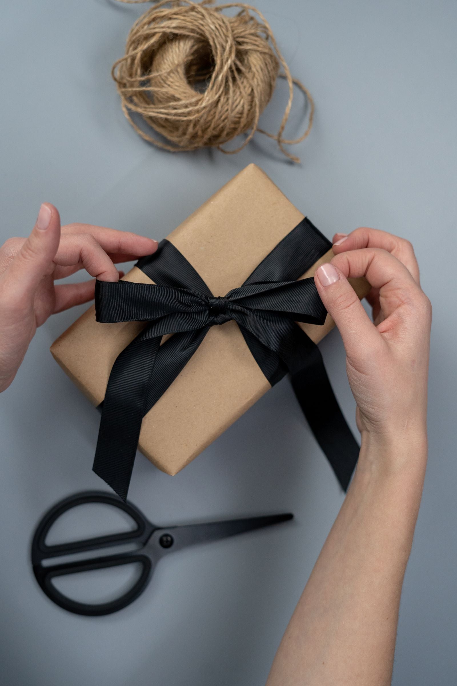 Kraft, black ribbon, and someone’s name on the box.